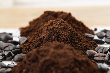 Coffee beans and powder on white background. grinding for espresso and alternative methods of brewing coffee