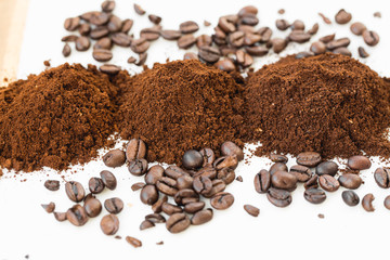 Coffee beans and powder on white background. grinding for espresso and alternative methods of brewing coffee