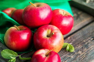 ripe red apples on wooden background