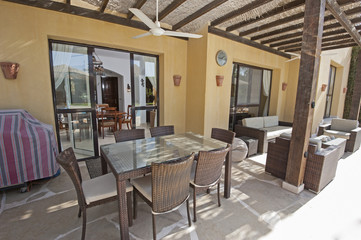 Patio area with sofa and dining table at a luxury tropical holiday villa resort