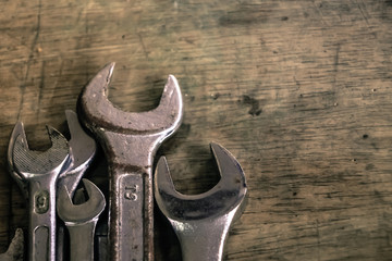 Close up wrench craftsman tool on wooden table, vintage  style