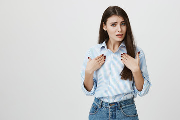 Portrait of offended and angry wealthy woman, pointing at her with both hands and lifting eyebrows...