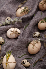 Chicken and quails eggs with decorative elements on black background