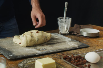 Male hands knead dough for cooking homemade cross buns