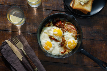 Fried eggs with bacon. Breakfast table concept