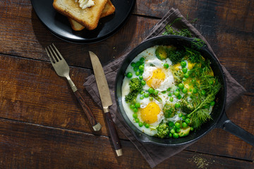 Fried eggs with vegetables. Healthy breakfast concept
