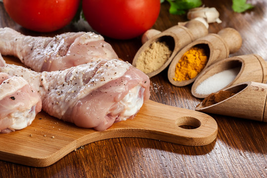 Raw chicken legs with spices