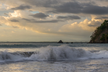 Tropical sunset with crashing waves on the coast in Costa Rica