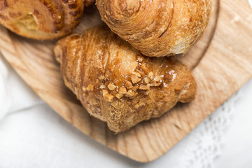 freshly baked buns with almonds. Croissants