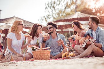 Group of friends having a party on the beach.