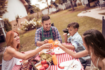 Happy family having lunch in the garden.