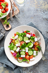 Fresh vegetable salad with feta cheese, fresh lettuce, cherry tomatoes, red onion and pepper
