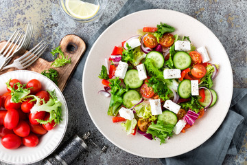 Fresh vegetable salad with feta cheese, fresh lettuce, cherry tomatoes, red onion and pepper