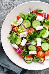 Fresh vegetable salad with feta cheese, fresh lettuce, cherry tomatoes, red onion and pepper