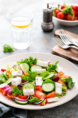 Fresh vegetable salad with feta cheese, fresh lettuce, cherry tomatoes, red onion and pepper