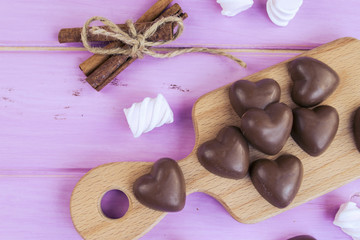 chocolate heart in a bucket on a pink wooden board