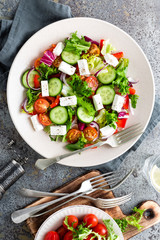 Fresh vegetable salad with feta cheese, fresh lettuce, cherry tomatoes, red onion and pepper