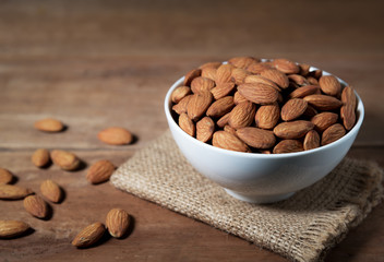 Almond snack fruit in white bowl on wooden