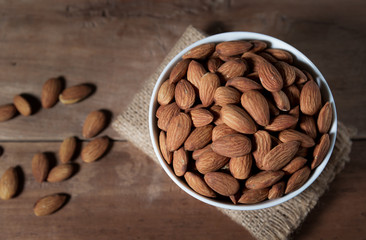 Almond snack fruit in white bowl on wooden