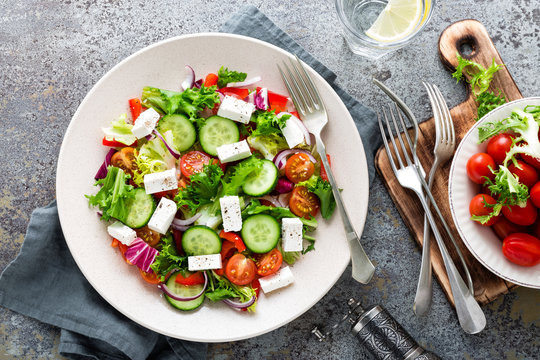 Fresh vegetable salad with feta cheese, fresh lettuce, cherry tomatoes, red onion and pepper