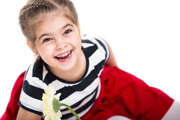 Portrait of a beautiful little cheerful girl on a white background. The child laughs