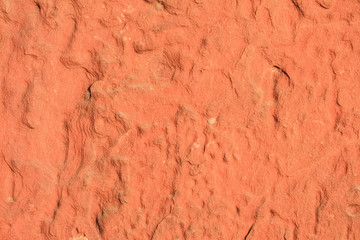 Red laterite stone surface texture background.