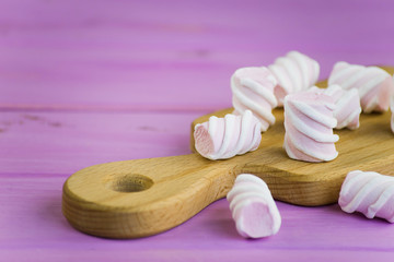 marshmallow candy on a pink wooden background
