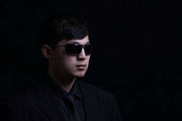 Obraz premium Portrait of a young Asian man. Close-up face on a black background