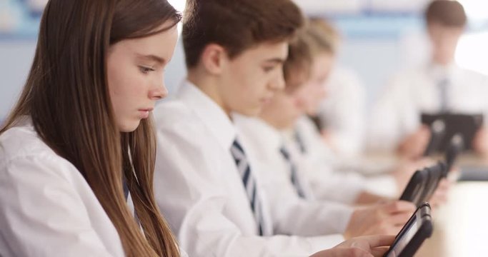 4k, Teenage school children with digital tablets in classroom