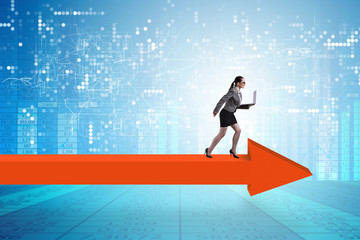 Fototapeta premium Businesswoman walking on arrow sign