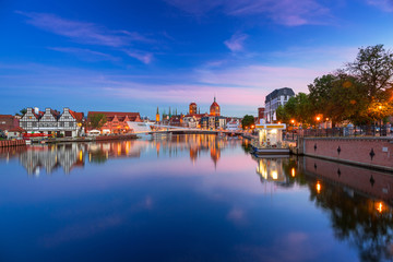 Fototapeta premium Old town in Gdansk and catwalk over Motlawa river at dusk, Poland