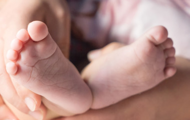 baby's foot in mother hand