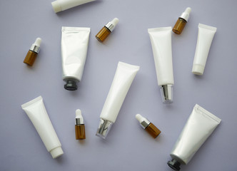 Natural cosmetic packaging.blank tube bottle container with green leaves. top view.mock up beauty product concept.