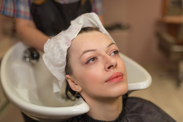 A woman is being washed in the hairdresser's beauty salon before a haircut