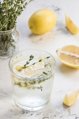 Detox water with lemon and thyme in glass