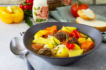 Beef stew  with vegetables in tomato sauce (carrots, tomatoes, saucesweet pepper, potatoes, paprika) on a stone background. The concept of healthy eating.