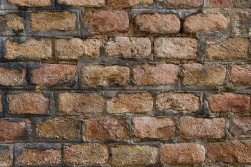 Very old pale red brick wall as background or wallpaper. Brick texture and pattern