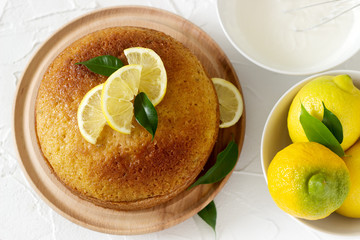 Lemon cake with whipped cream on a light background.