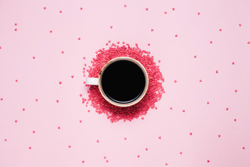 Cup of black coffee and pink hearts on pink background. St valentine's day concept, woman's day. top view, flat lay