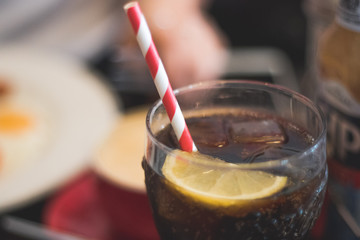 Fizzy drink with stripy straw