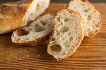 A baguette on a wooden background.