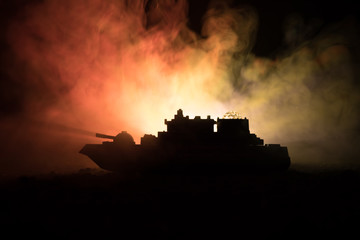 Fototapeta premium Silhouette of military war ship on dark foggy toned sky background.