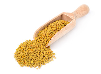 Bee pollen in a wooden scoop. isolated on a white background. Natural remedy for immunity enhancement. Beekeeping products. Apitherapy.