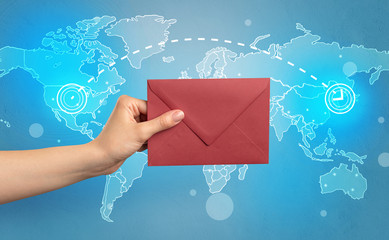 Hand holding envelope with global concept