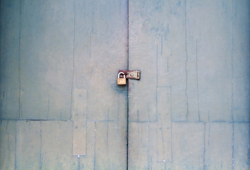 The old vintage retro door made of hardwood. Large green wooden door locks with keys made of steel.