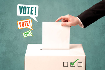 placing a voting slip into a ballot box