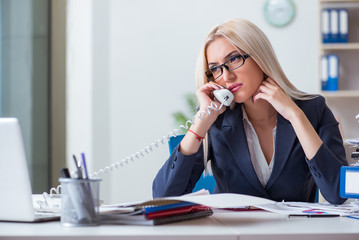 Fototapeta premium Busy businesswoman working in office at desk