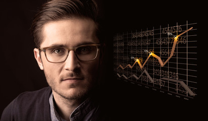 Happy businessman with a growing graph