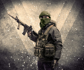 Fototapeta premium Portrait of a dangerous masked armed soldier with grungy background