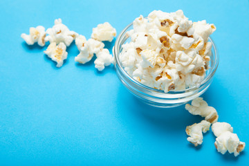 Glass bowl of freshly popped popcorn isolated.